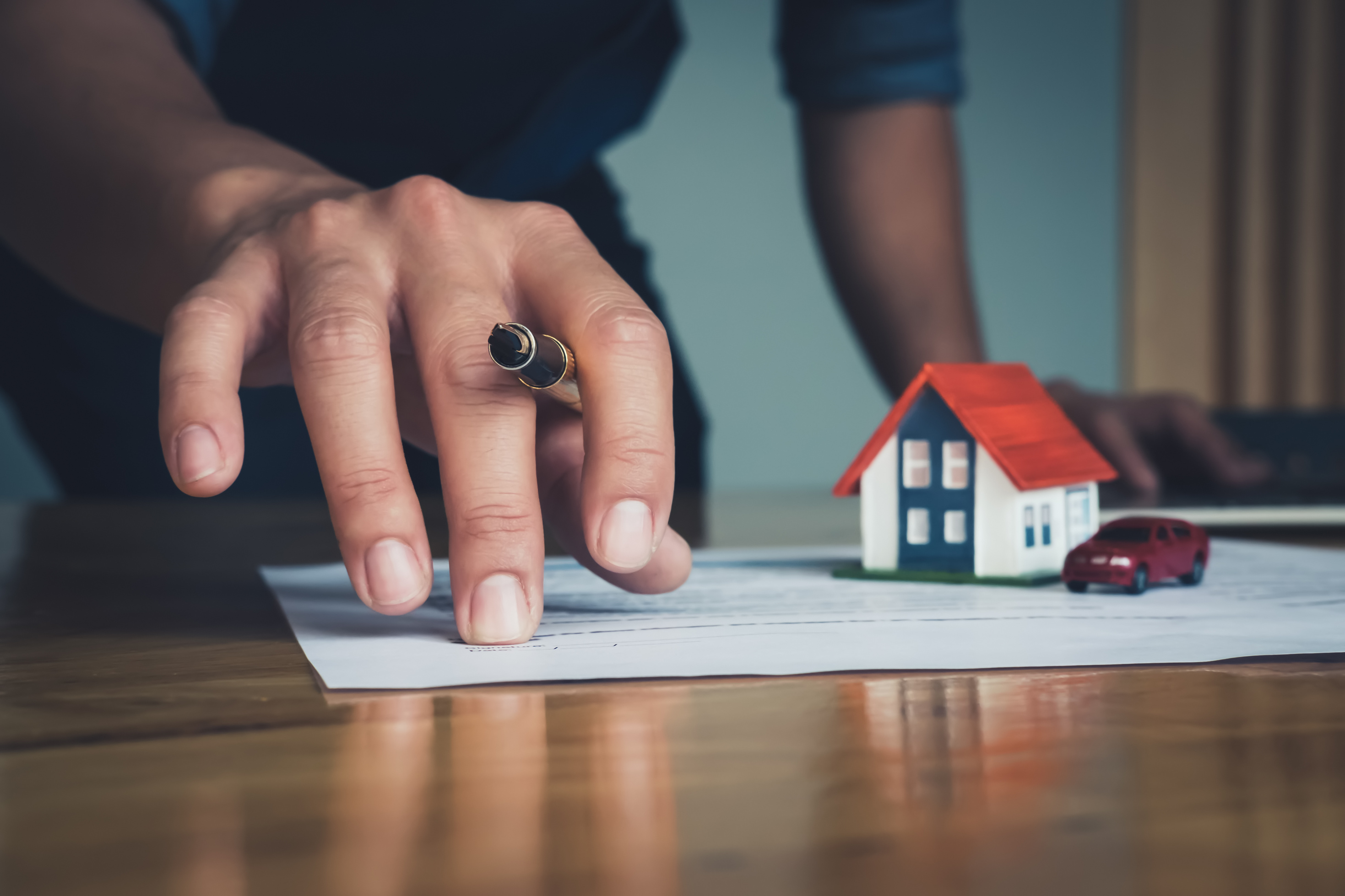 Real Estate Agent Holding House to His Client 